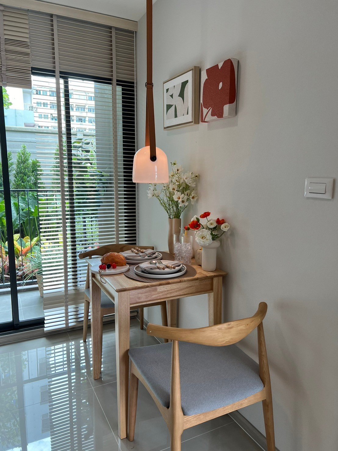 dcondo Calm: Dining table for two by the balcony in the condo's kitchen area.