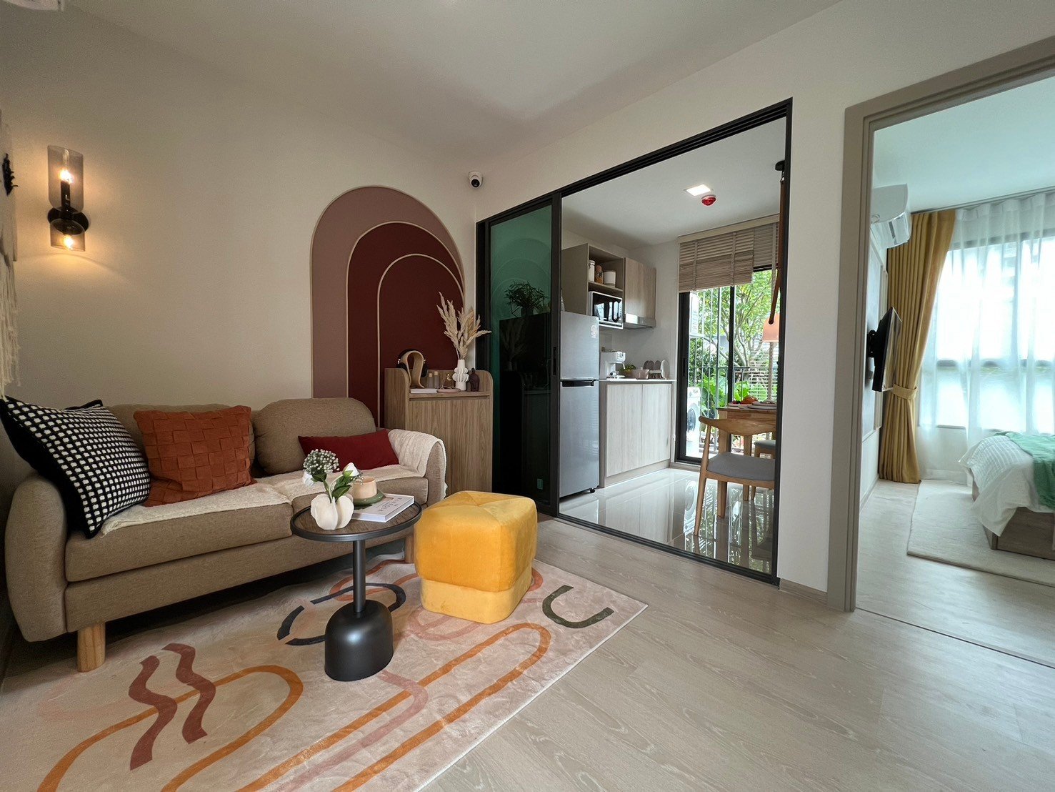 dcondo Calm: Full view of a one-bedroom apartment living space, kitchen, and bedroom entrance.