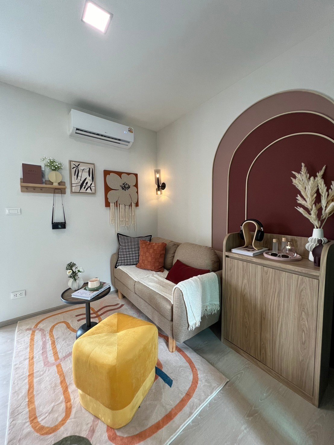 dcondo Calm: High-angle view of the living room highlighting the sofa and wall art.