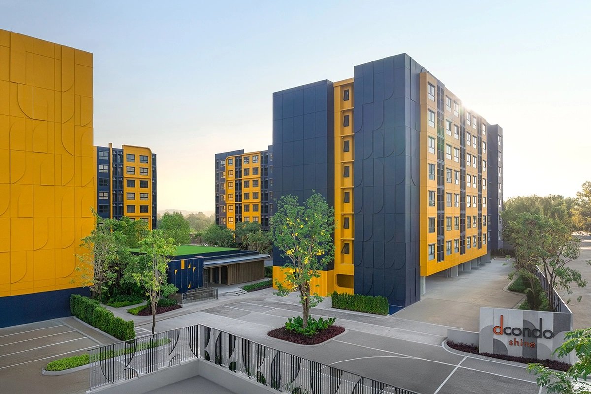 dcondo Shine Rangsit: Exterior view of the colorful yellow and dark blue buildings of dcondo Shine Rangsit.