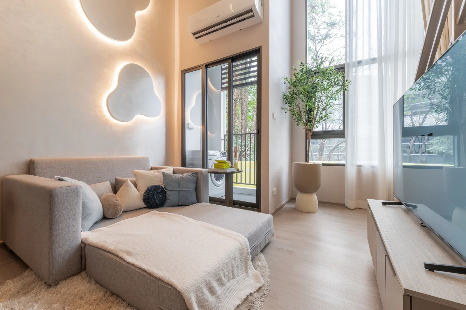 Living area in a different one-bedroom high-ceiling show apartment, not A1606.