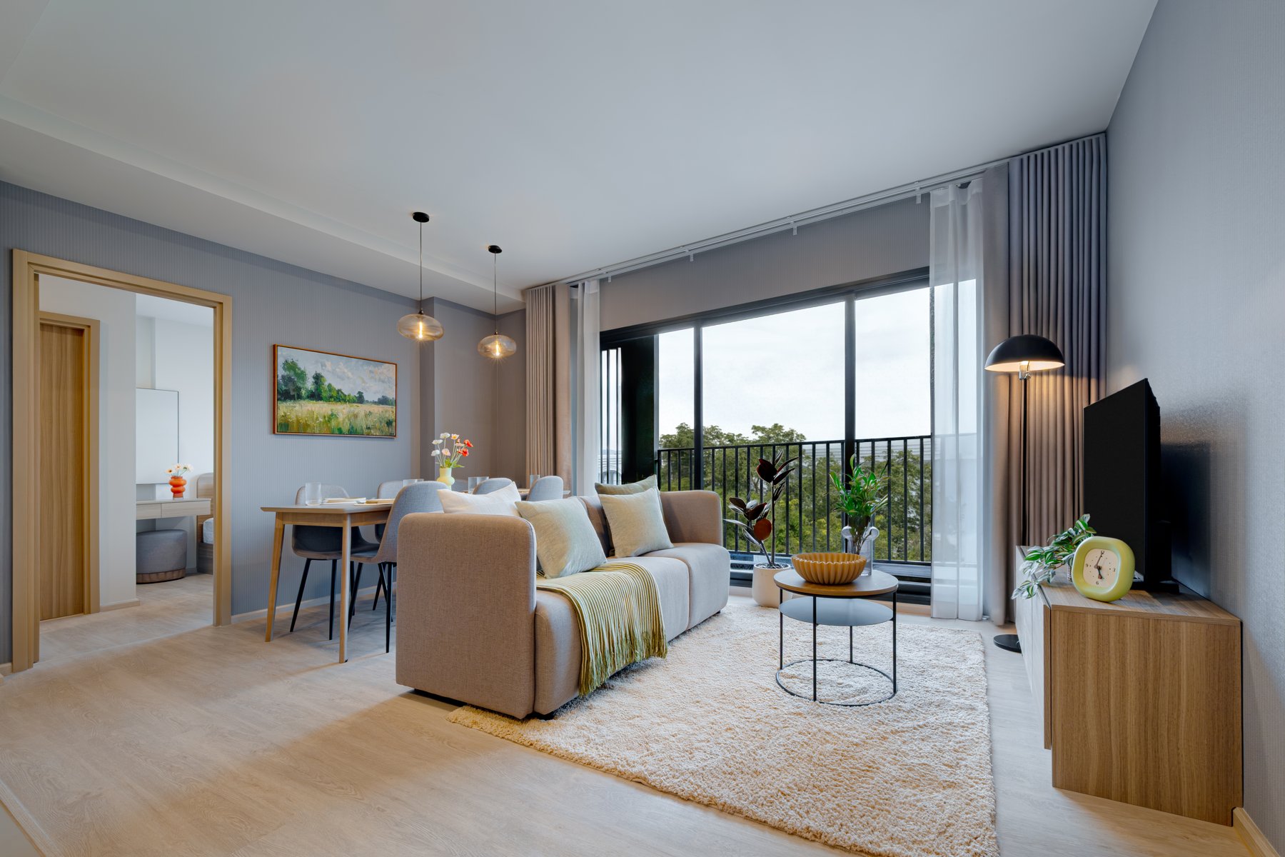 The Base Cherngtalay: Cozy living room with access to a balcony overlooking the natural surroundings.