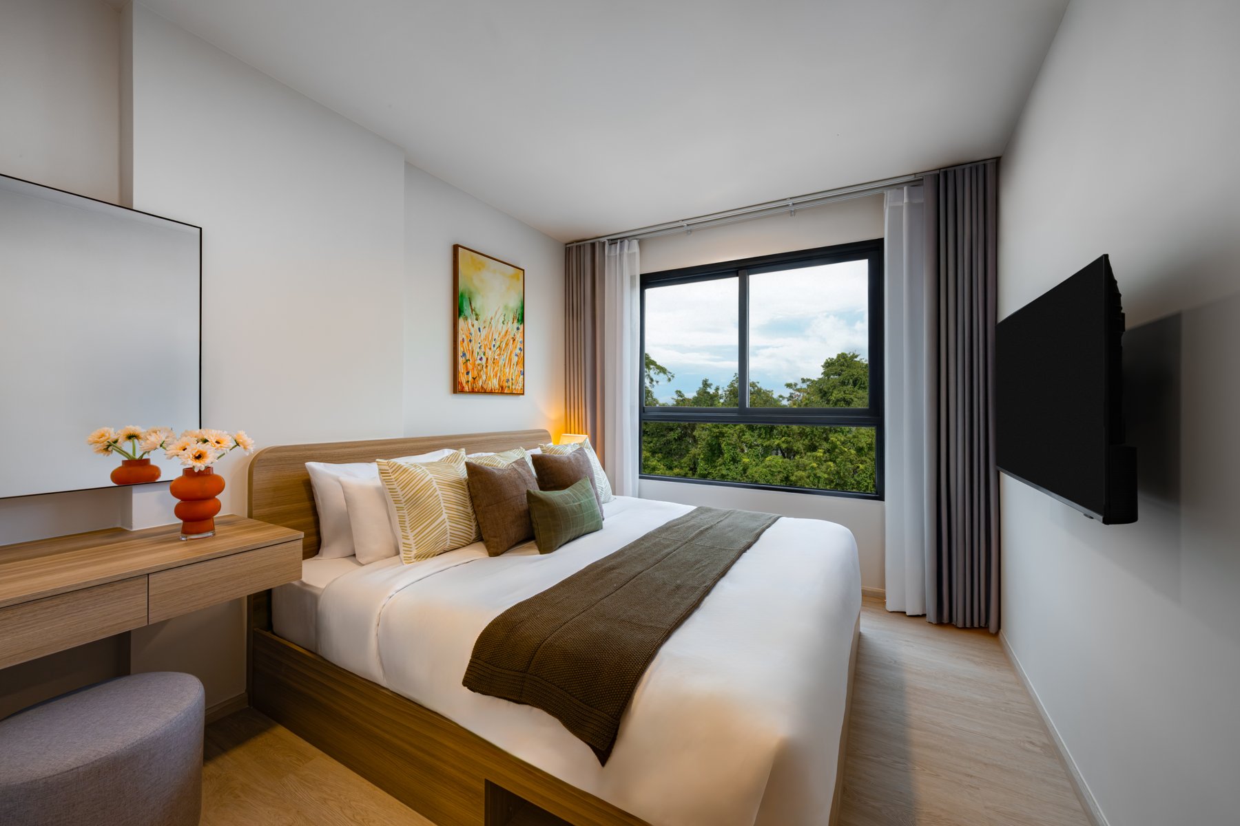 The Base Cherngtalay: Master bedroom with large window and views of the greenery.