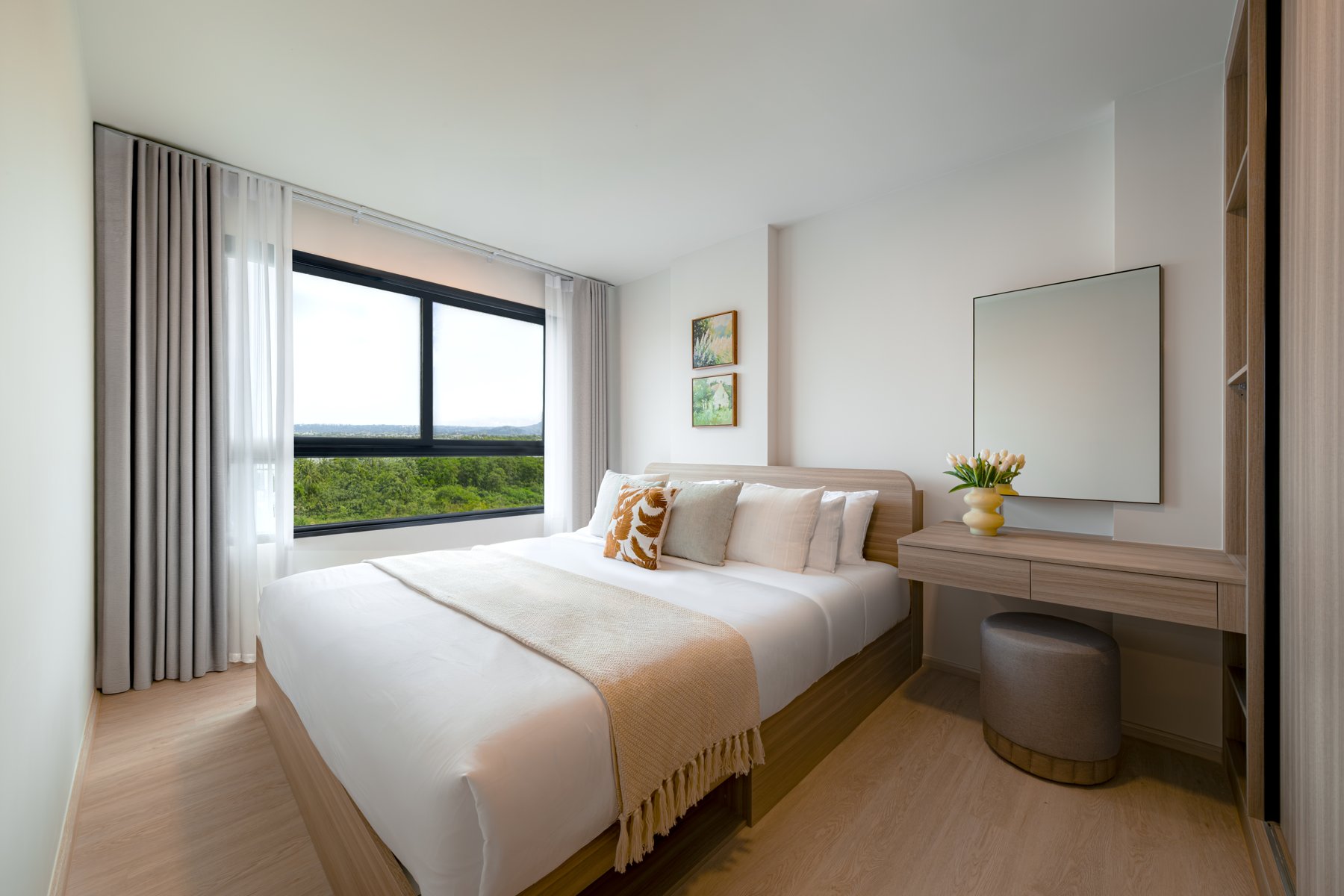 The Base Cherngtalay: Bright secondary bedroom with a built-in wardrobe and vanity.