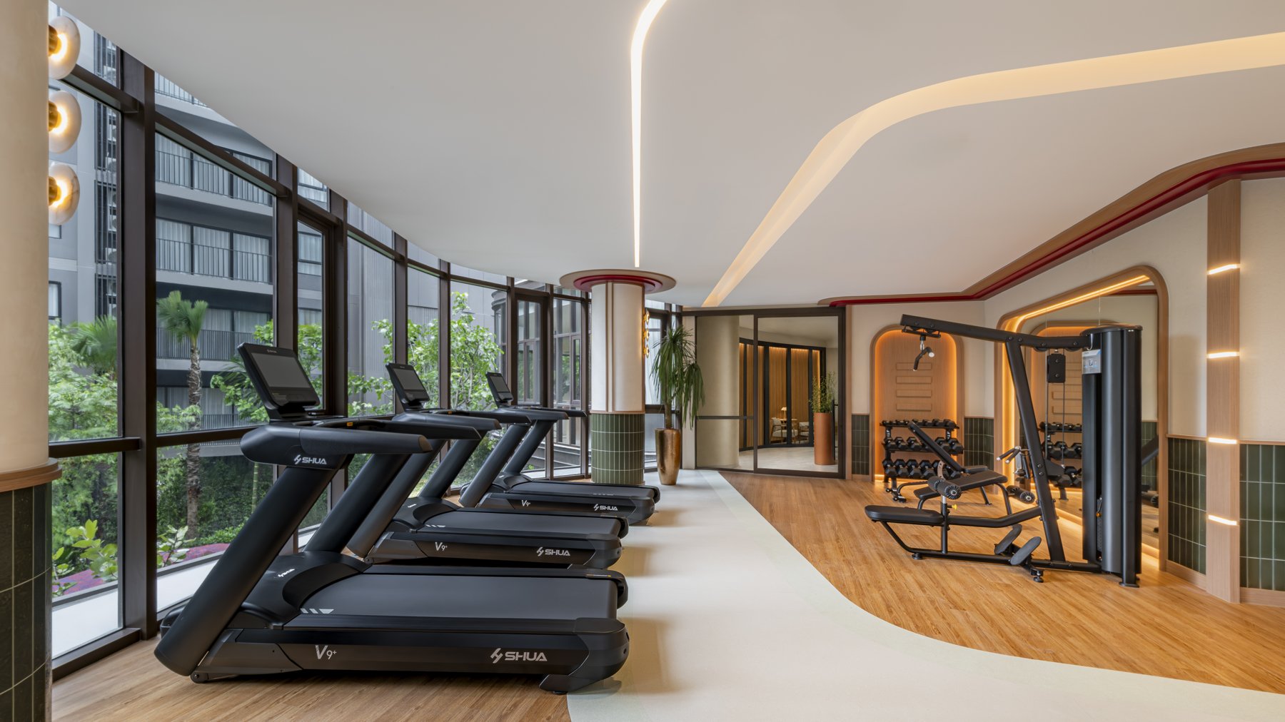 The Base Cherngtalay: The fitness center with treadmills overlooking the gardens.